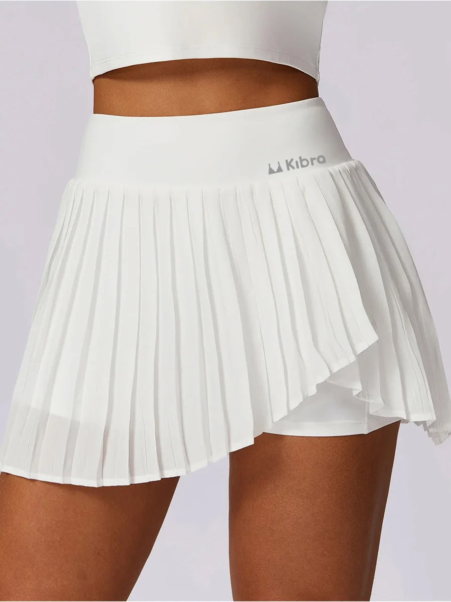 A sporty classic with a fresh street-style edge- High-Waisted Asymmetric Pleated Skort — Black/Pockets