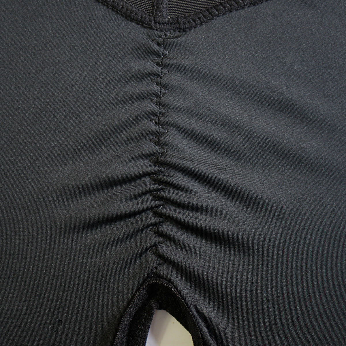 Full-body women’s shapewear bodysuit with front zipper closure, deep V-neckline, and mid-thigh smoothing coverage