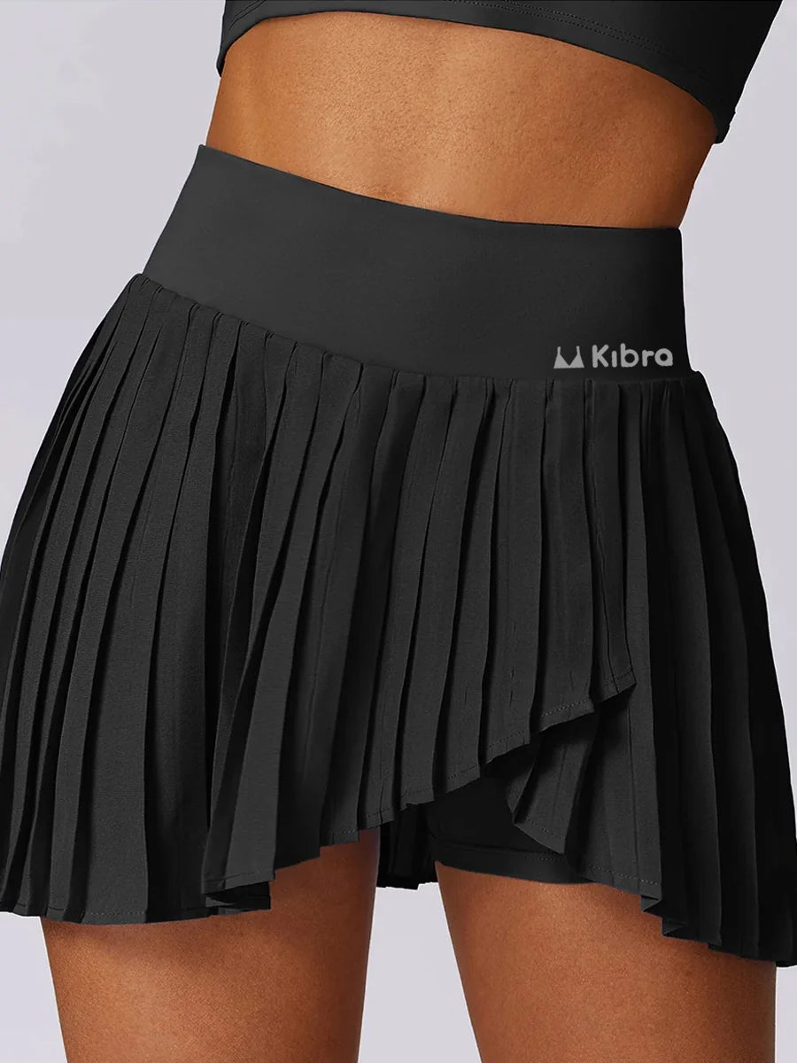 A sporty classic with a fresh street-style edge- High-Waisted Asymmetric Pleated Skort — Black/Pockets