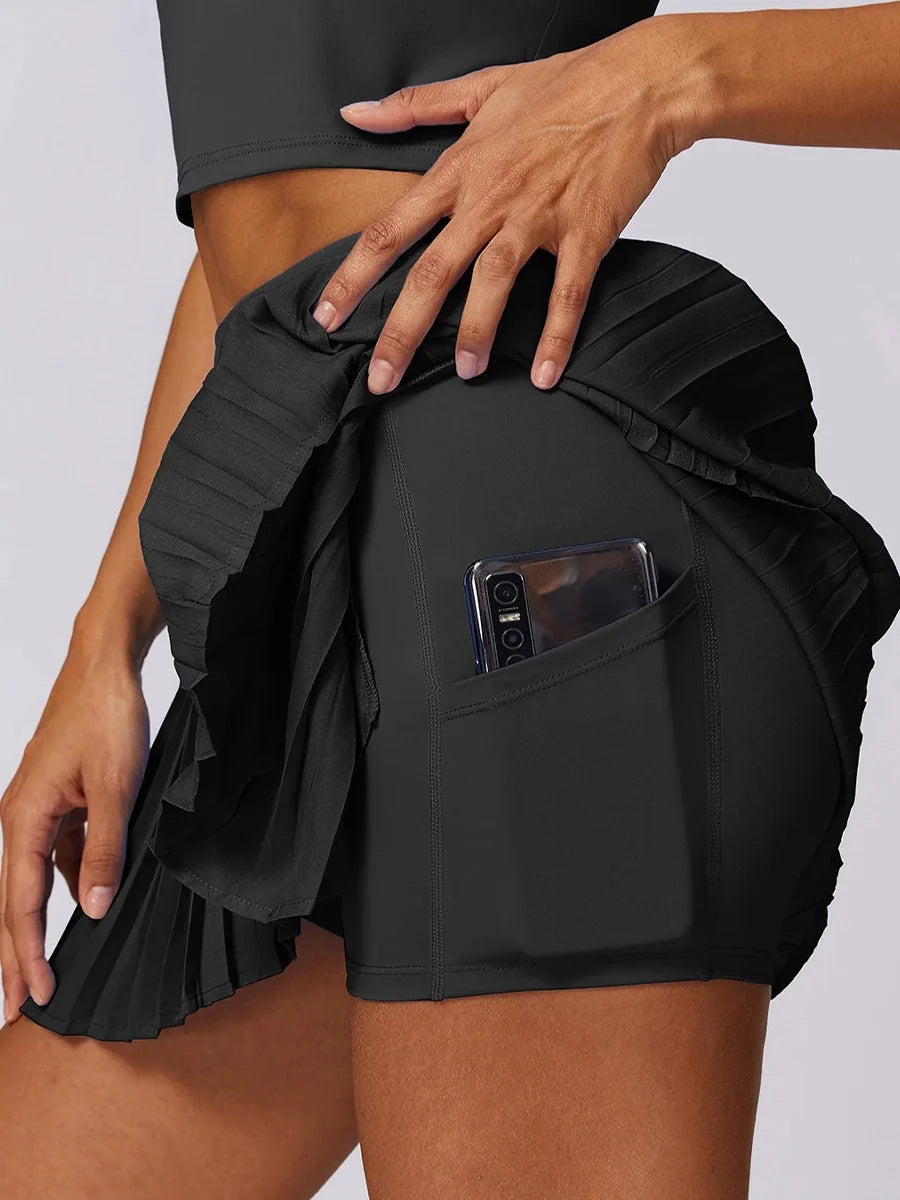 A sporty classic with a fresh street-style edge- High-Waisted Asymmetric Pleated Skort — Black/Pockets
