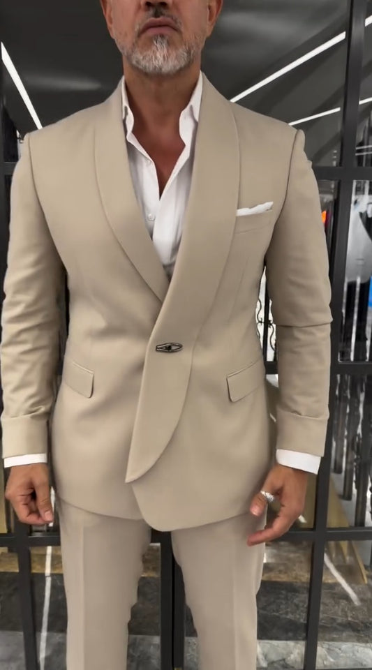 A polished men’s beige suit set featuring a structured blazer, matching trousers, and a modern tailored fit