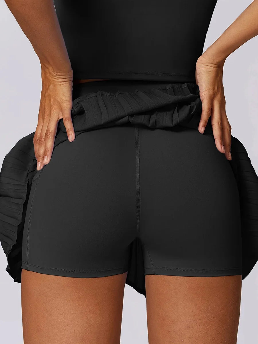 A sporty classic with a fresh street-style edge- High-Waisted Asymmetric Pleated Skort — Black/Pockets