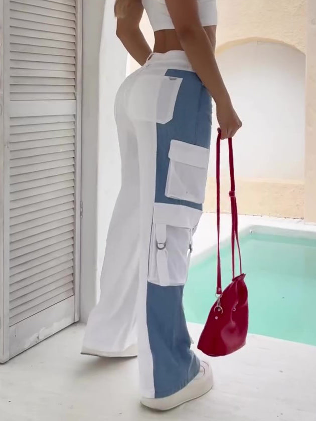 Women’s high-waist colorblock cargo pants featuring a wide-leg fit, bold blue-and-white contrast panels, and oversized utility pockets for a fresh streetwear-inspired look