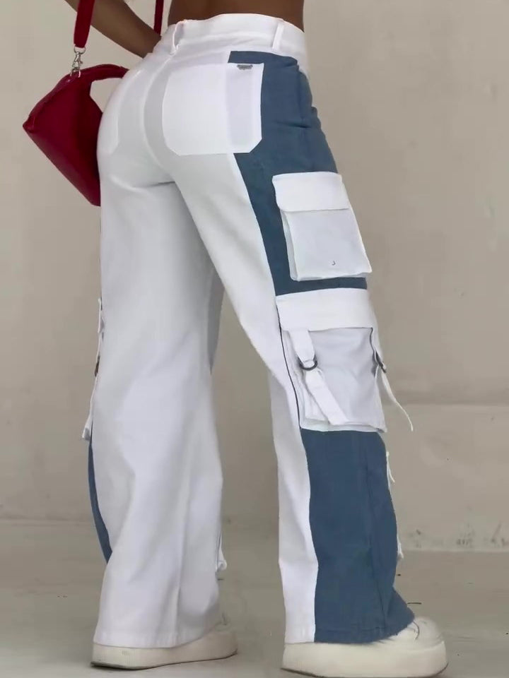 Women’s high-waist colorblock cargo pants featuring a wide-leg fit, bold blue-and-white contrast panels, and oversized utility pockets for a fresh streetwear-inspired look